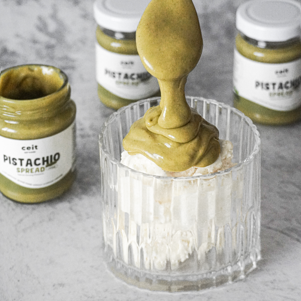 Halal pistachio spread drizzling over low sugar dessert for a healthy diet.
